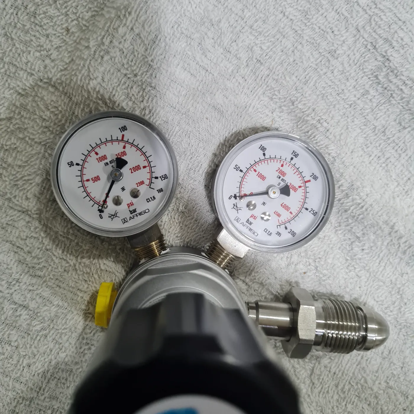 Twin pressure gauges on a gas regulator at the Airgas workshop